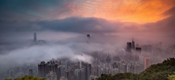 'Sunrise Glow Decorates The City In Fog'