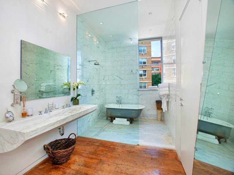 the-bathroom-is-more-modern-with-glass-and-mirrors-defining-the-perimeters