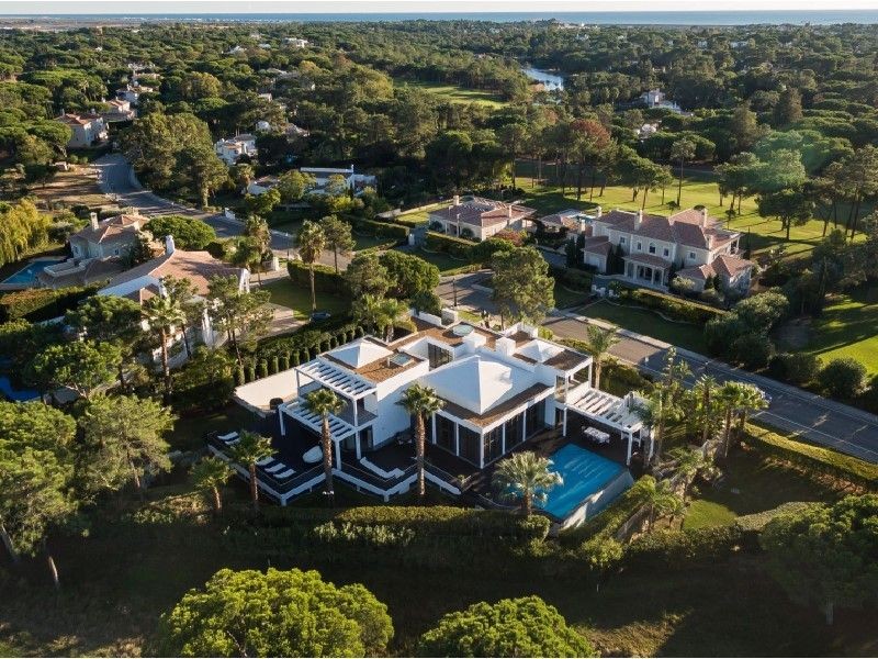 A bird's eye view of the property with the sea in the background A bird's eye view of the property with the sea in the background