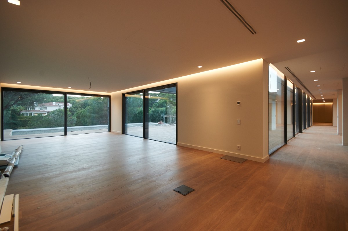 There are large floor-to-ceiling windows in the living spaces