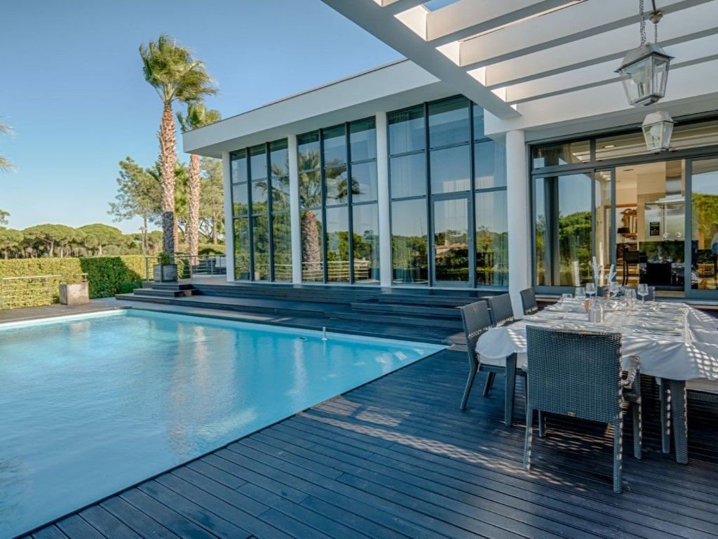 The villa has an impressive pool with lounge areas