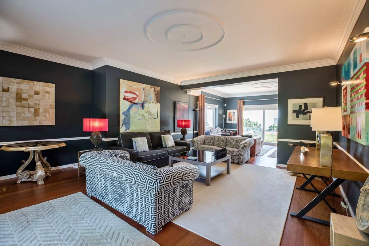 The living room has large windows letting in natural light