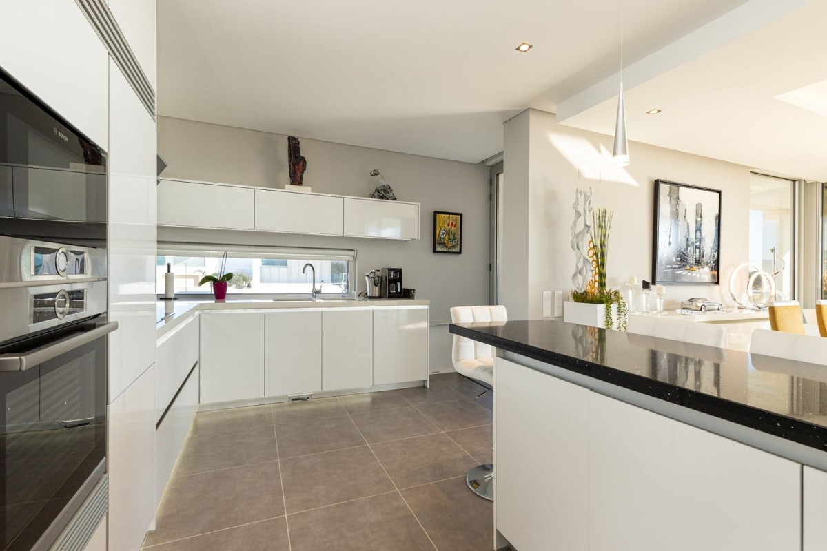 The large, modern kitchen is open and bright 