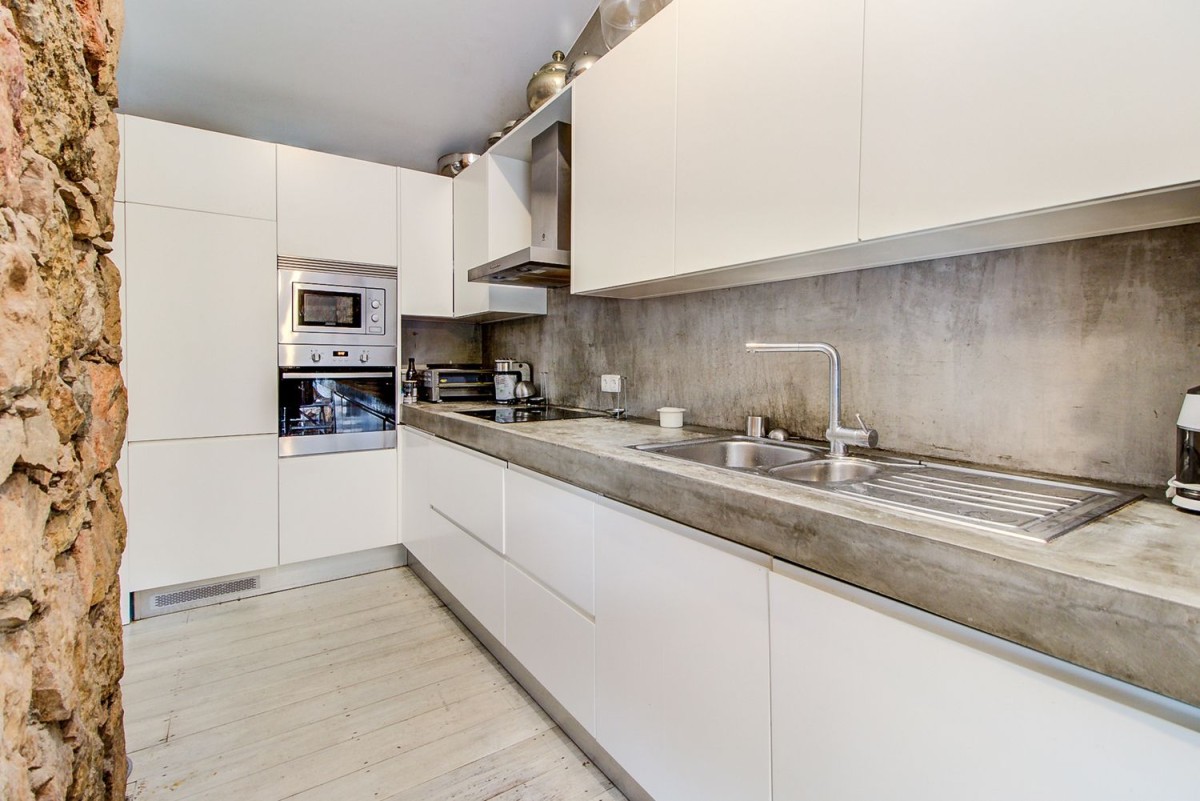 The kitchen is modern and spacious