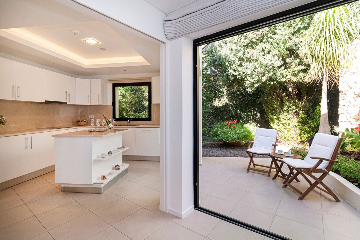 The modern kitchen leads onto a charming patio area