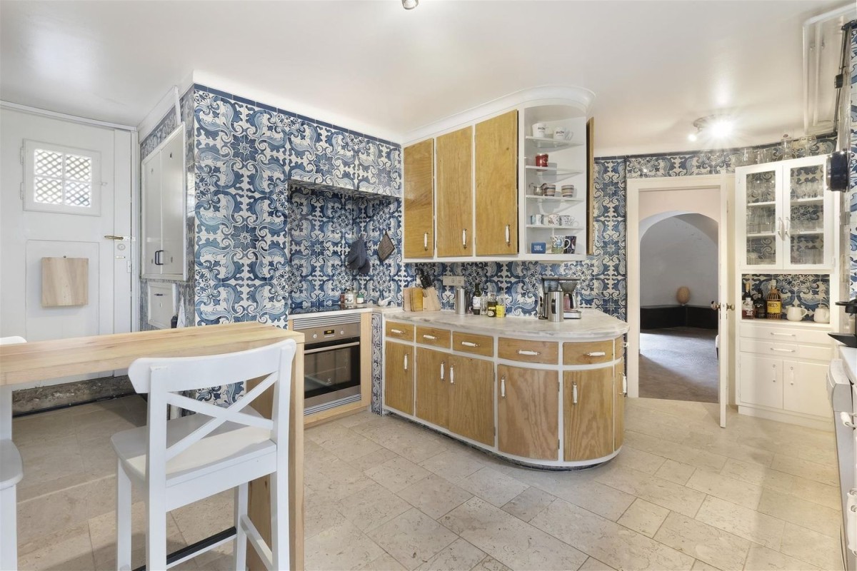 The kitchen in unique and makes use of traditional Portuguese tiles