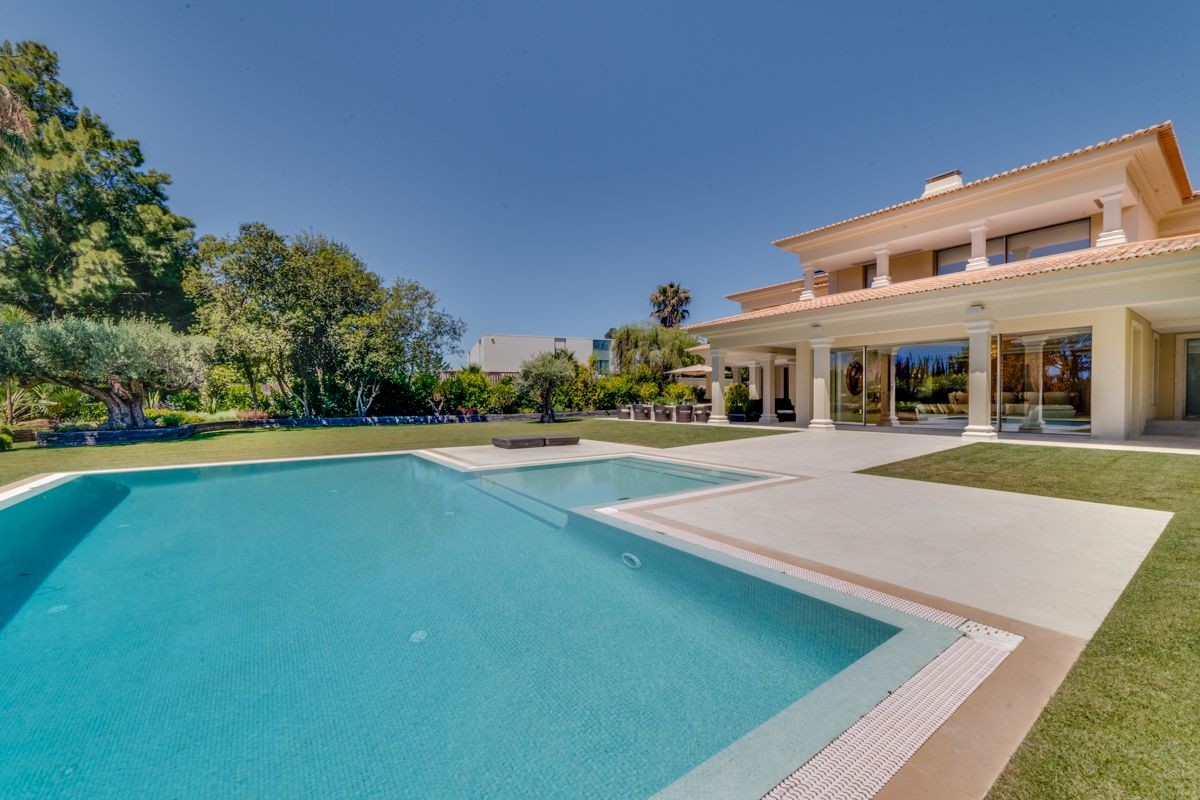 The villa is surrounded by a beautiful garden and pool