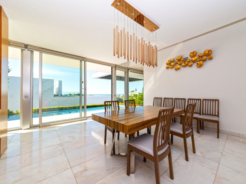 The dining room enjoys views over the pool
