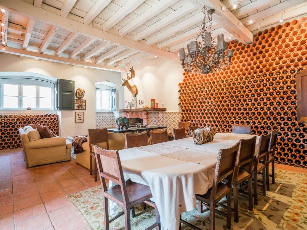 The dining area has a unique wall perfect for storing wine