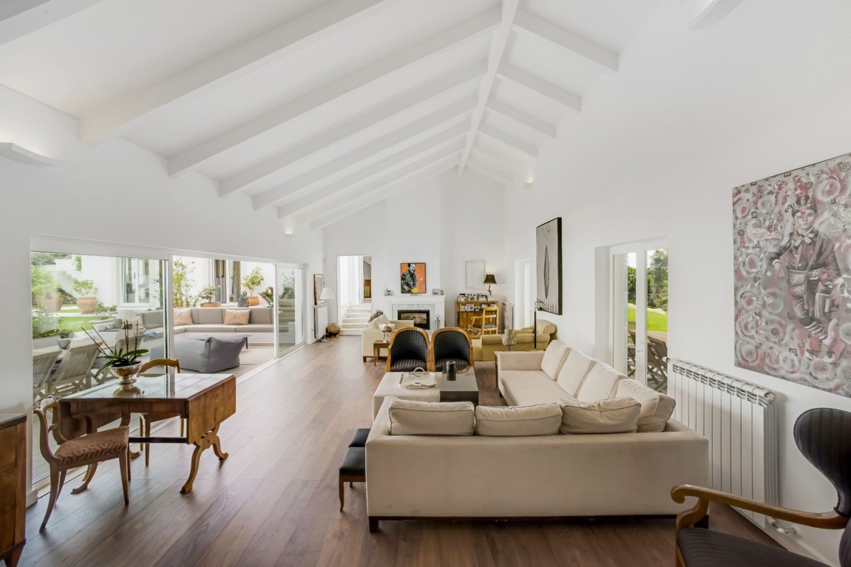 The living room has beautiful wooden ceiling features