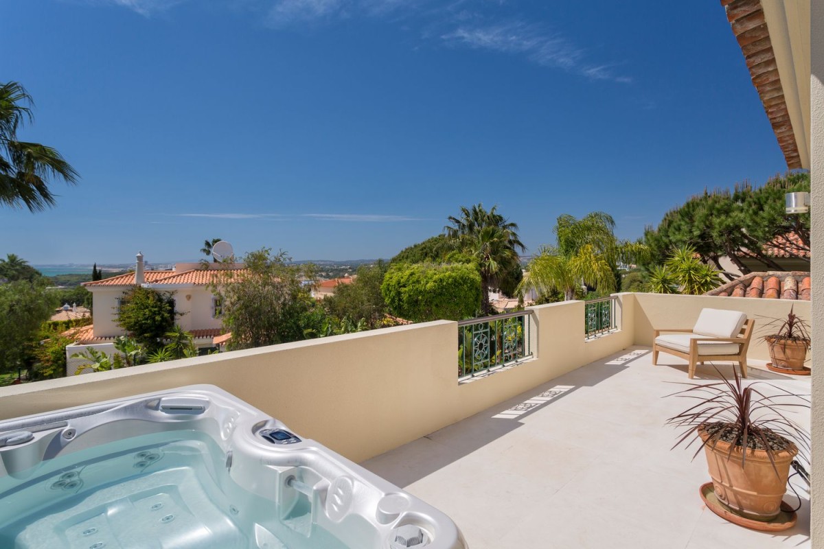 The villa has a spacious balcony with a hot tub and panoramic views