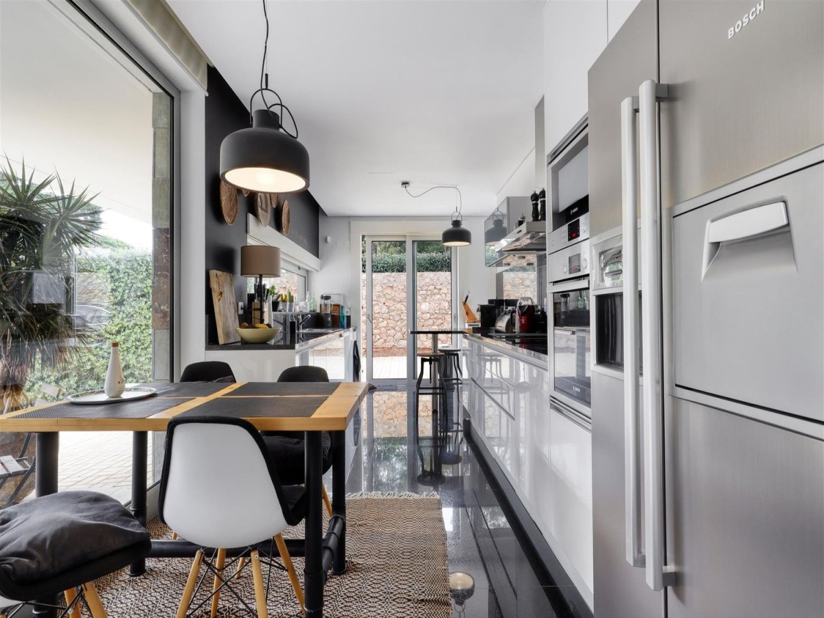 The kitchen is modern and has direct access to the exterior