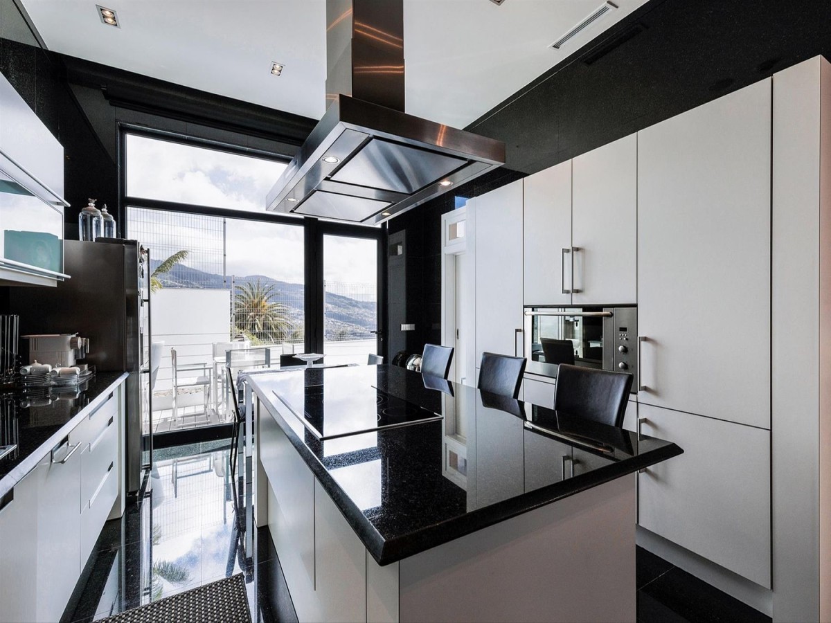 The kitchen has a modern design and has a breakfast bar