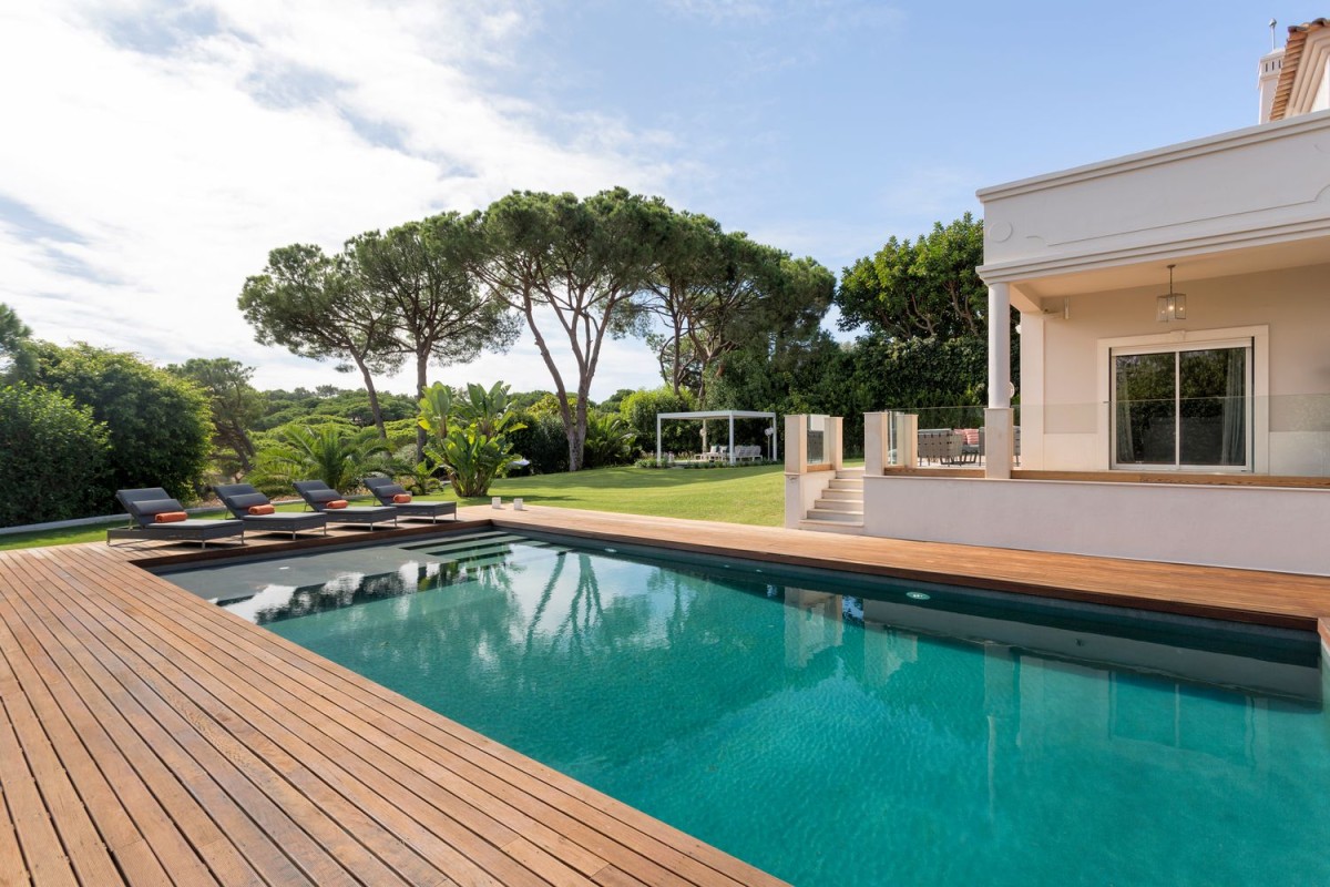 The villa has a large swimming pool and deck