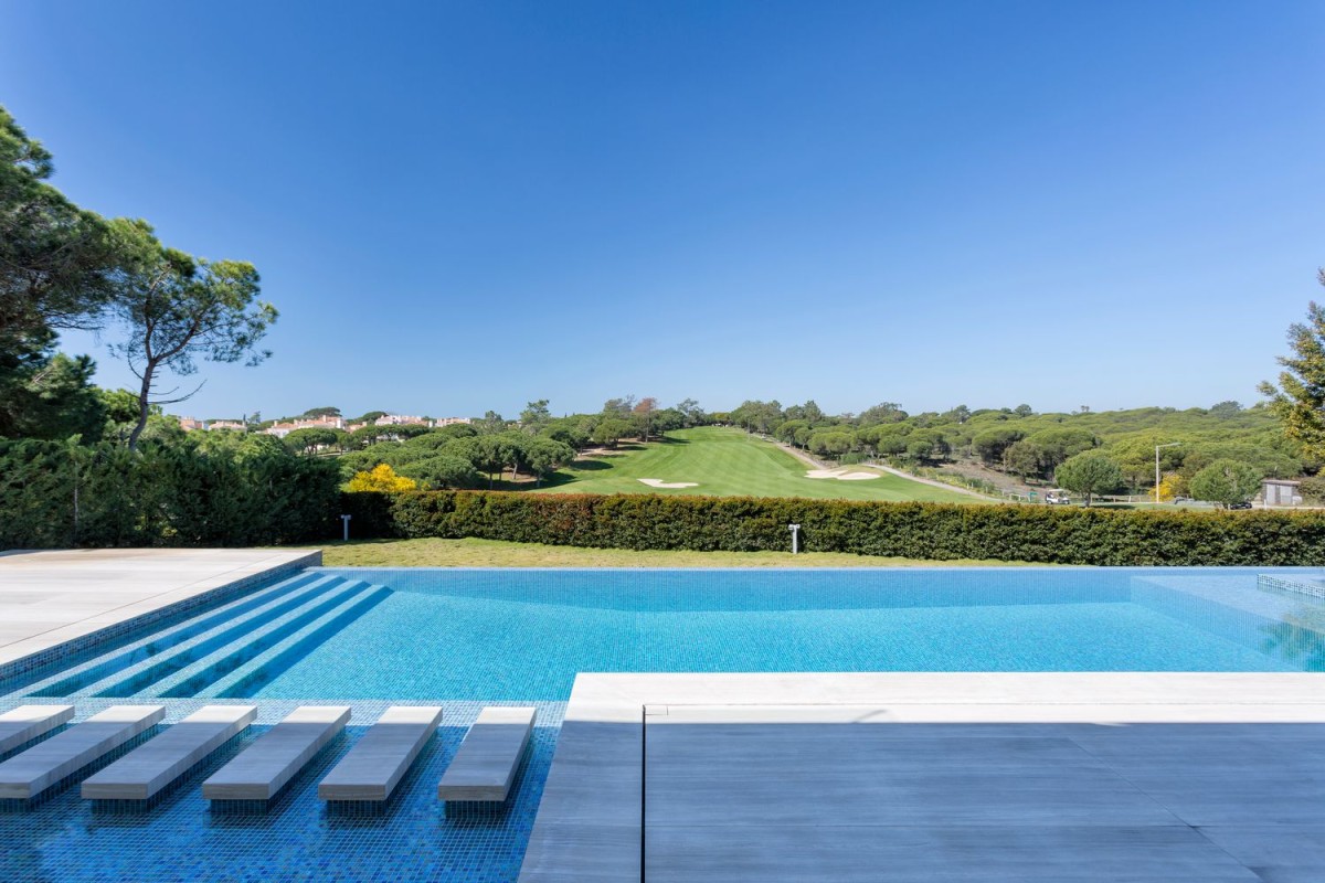 The stunning swimming pool has views of the golf course