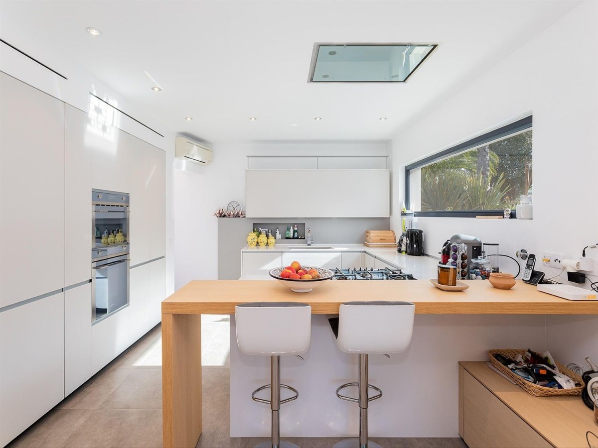 The modern kitchen has a breakfast bar