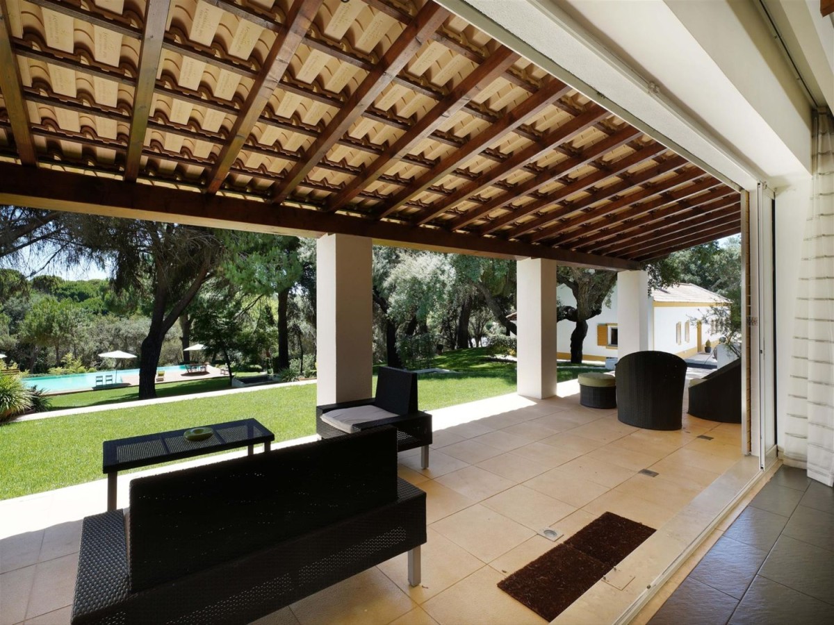 The veranda looks down on the pool through the trees