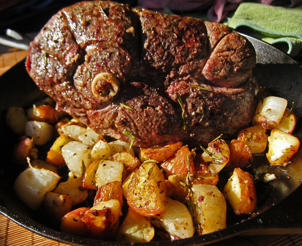 Roast lamb is usually enjoyed on a bed of potatoes at Easter